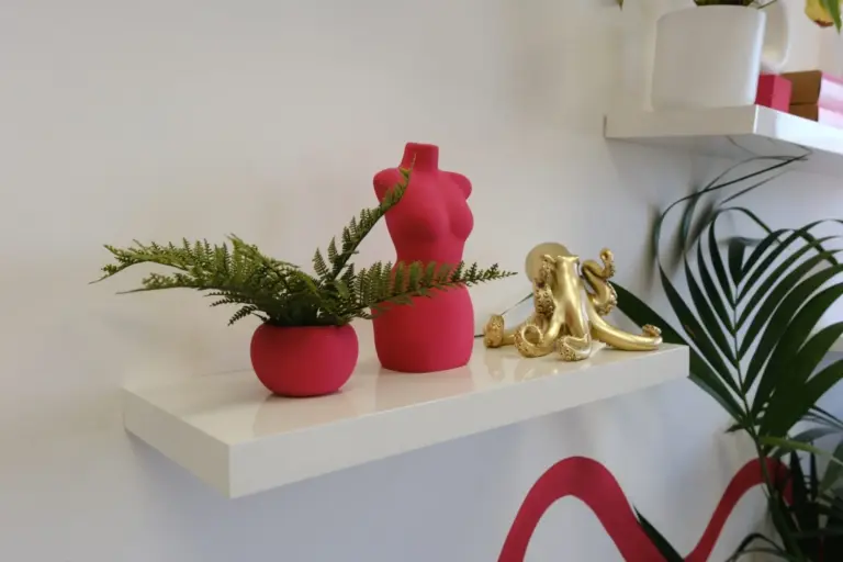 Pink and gold sculptures on a shelf