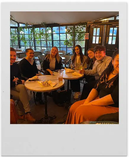 Manton Executives staff sitting at tables with food and drinks