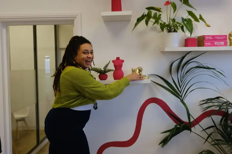 Posing in front of shelves with ornaments