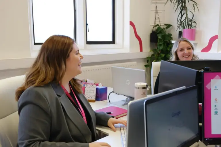 Laughing whilst sitting at a desk